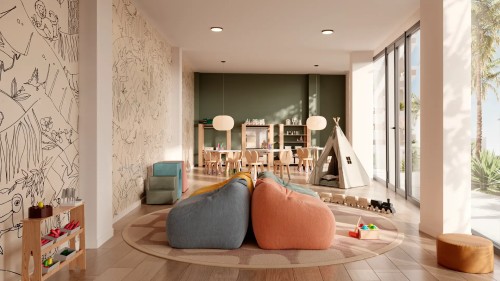 Sala polivalente o ludoteca infantil en el residencial Insur Elyonia. Espacio seguro y luminoso con juegos de madera, tipis y murales decorativos para el disfrute de los más pequeños.